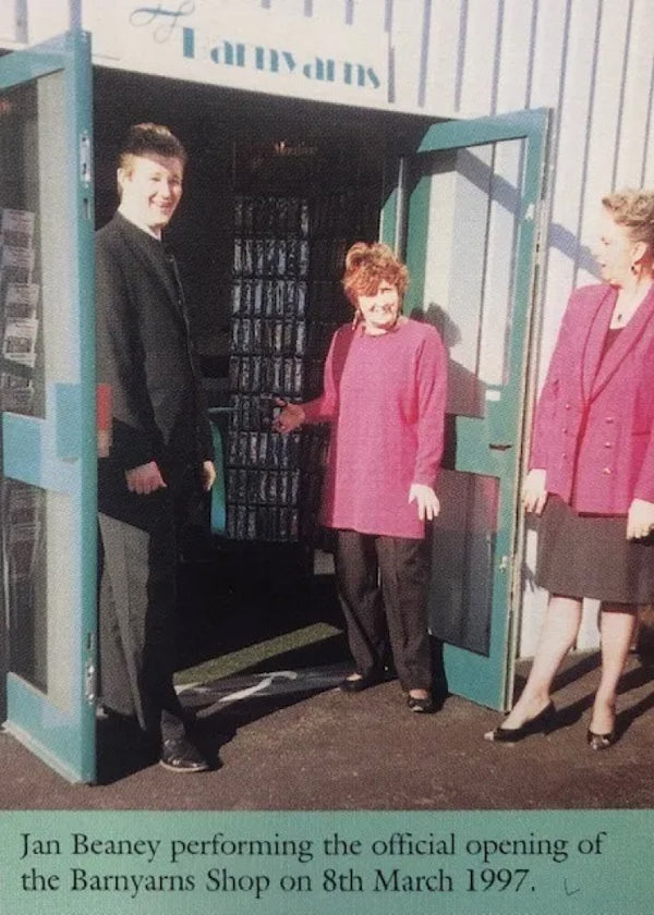 photograph from 1997 of Jan Beaney cutting the ribbon at the opening of the barnyarns shop.