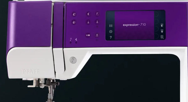 Pfaff expression 710 model in purple and white with a digital screen close up.
